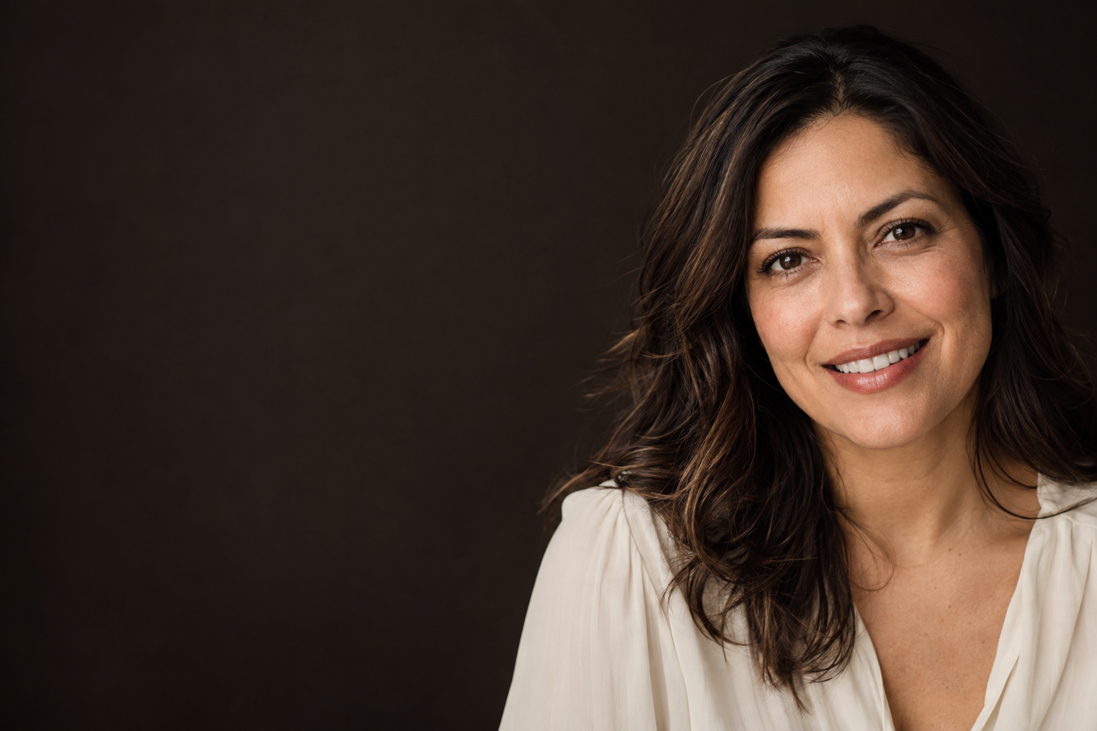 Retrato editorial ilustrativo de una mujer con una sonrisa natural; no corresponde a una paciente de la clínica.